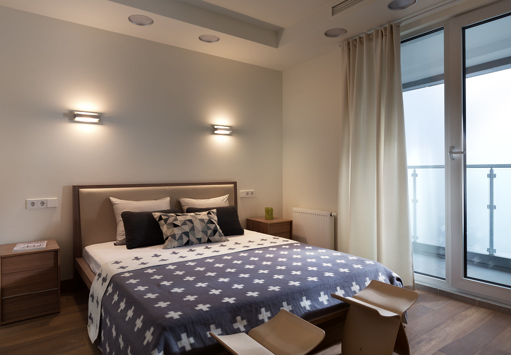 A bedroom with the balcony doors open